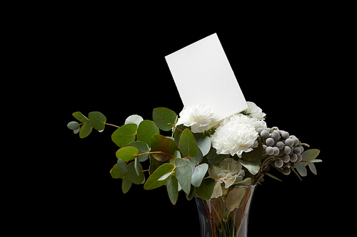 Floral bouquet with white card isolated on black