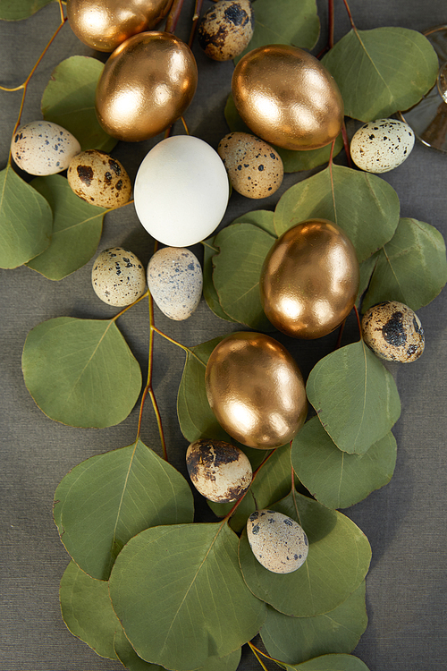 top view of golden easter eggs on green leaves
