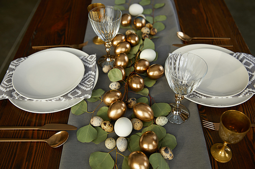 high angle view of golden easter eggs on wooden table in restaurant
