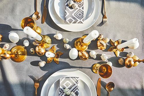 top view of easter decorated table with golden eggs