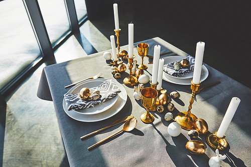 high angle view of easter decorated table with golden eggs