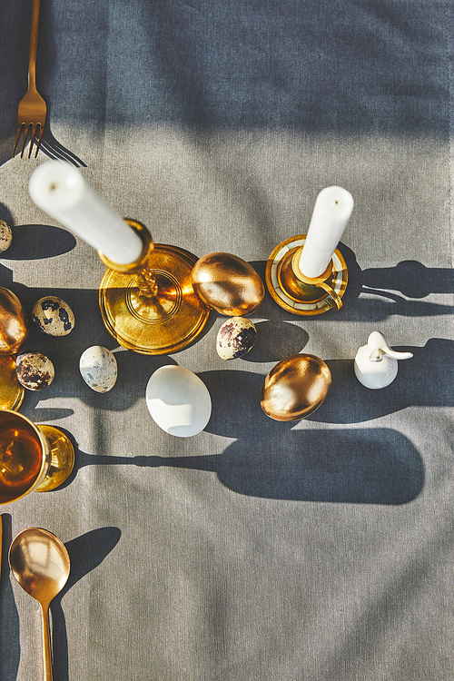 top view of candles and easter eggs on festive table
