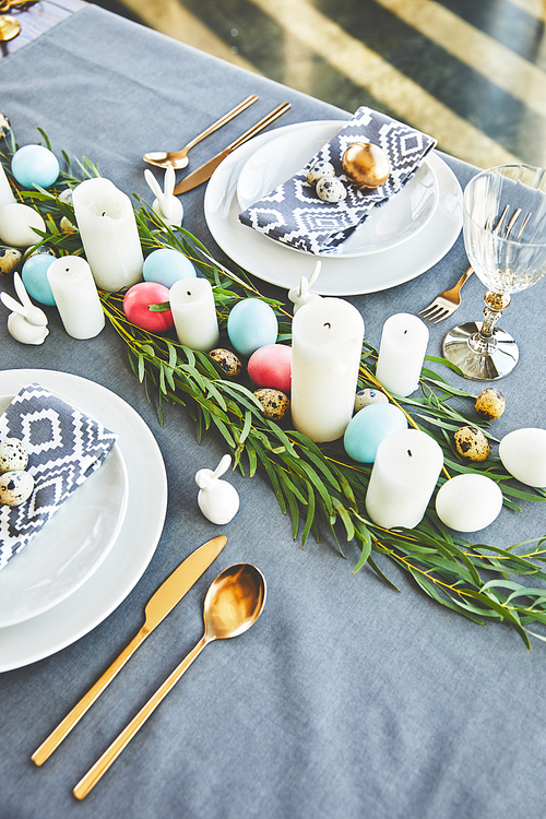 high angle view of easter eggs and candles on festive table