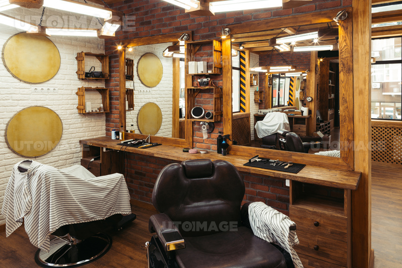 유토이미지 | empty chairs reflected in mirrors in modern barbershop