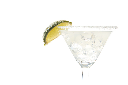 Close up view of margarita cocktail with lime piece and ice isolated on white