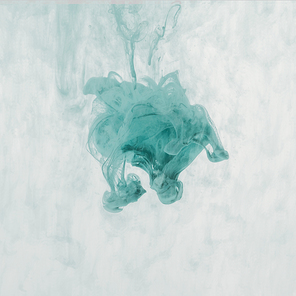 artistic splash of turquoise paint in water