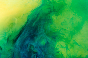 artistic background with green paint flowing in water