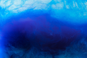 abstract background with blue acrylic paint flowing in water