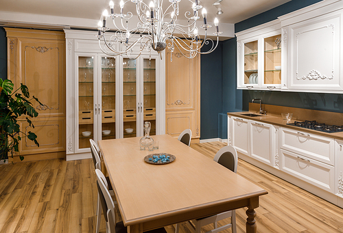 Renovated kitchen interior with chandelier over table