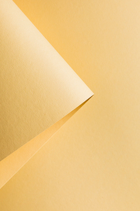 close-up view of rolled yellow paper sheet abstract background