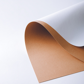 close-up view of white and brown paper sheets on grey background