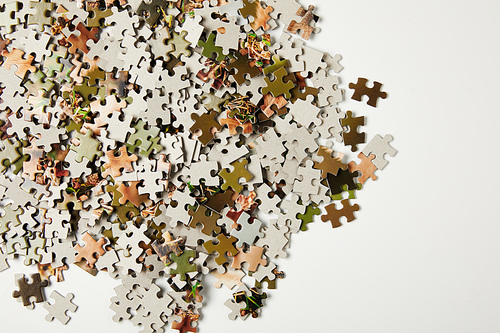 top view of jigsaw puzzle pieces with copy space on grey
