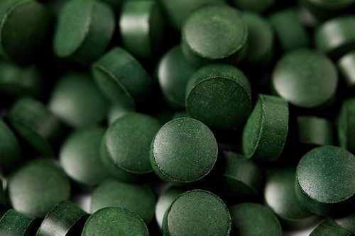 full frame image of pile of spirulina pills background