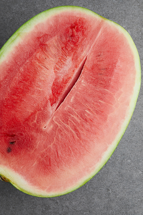 top view of fresh watermelon cut half on grey concrete tabletop