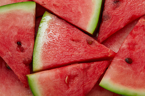 full frame of arranged watermelon slices as background
