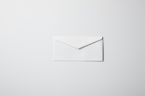 top view of blank envelope on white surface for mockup