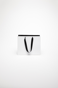one black and white paper shopping bag isolated on white