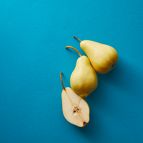 top view of appetizing pears on blue surface