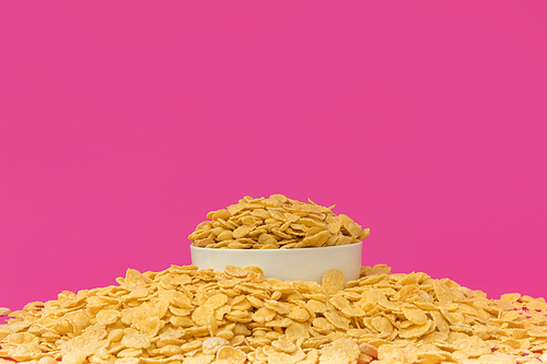 close-up view of white bowl with sweet crunchy corn flakes isolated on pink