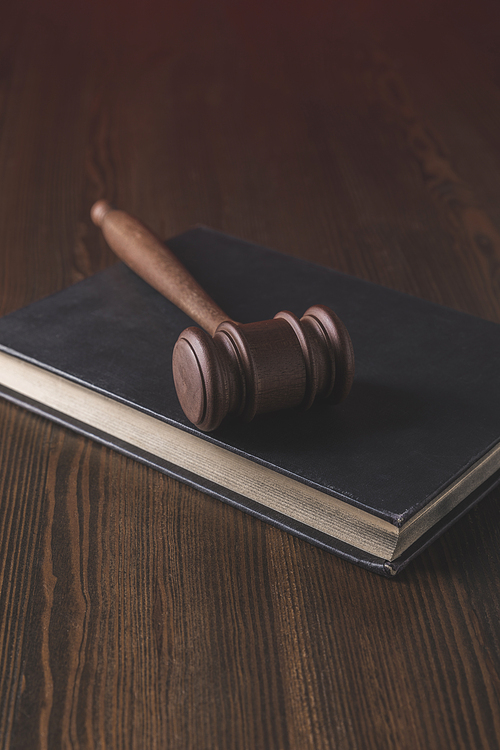 juridical book with hammer on wooden table, law concept