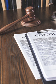juridical contract on wooden table with hammer , law concept