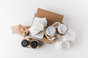top view of pizza boxes and disposable coffee cups with noodles boxes on white
