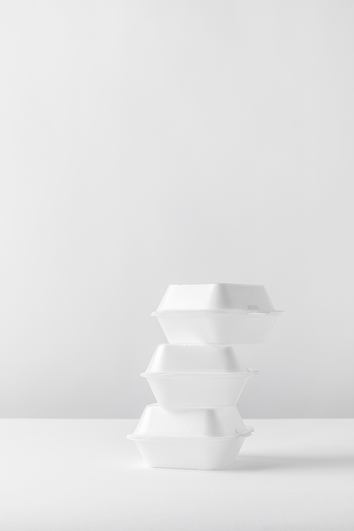 three white food containers on white table