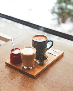 Hot coffee with milk in table in coffee shop