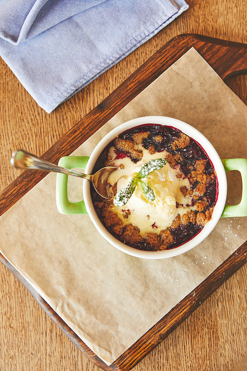 Berry crumble served in pot on table