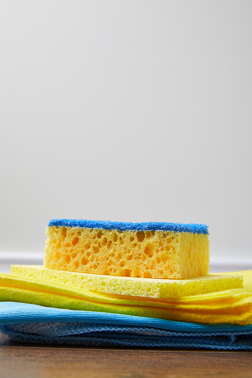 yellow and blue rags and washing sponge for spring cleaning