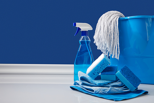 blue rags, bucket and spray for spring cleaning