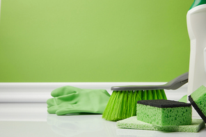 green brush and washing sponges for spring cleaning