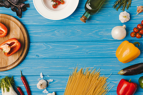 top view of blue table with pasta ingredients