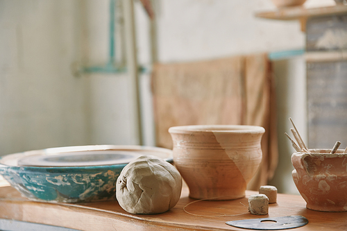 selective focus of clay and pottery tools at table in workshop