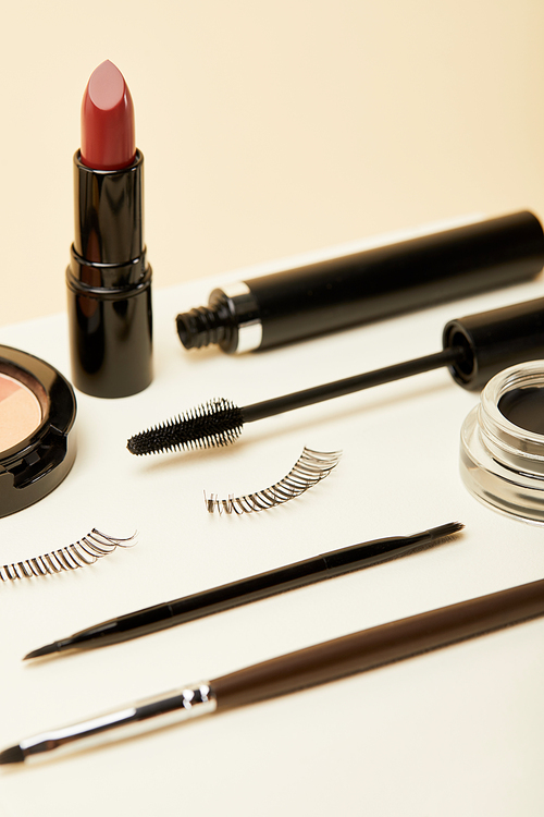 close-up shot of makeup accessories kit on beige