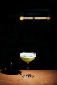 selective focus of delicious cocktail with foam on black background with copy space