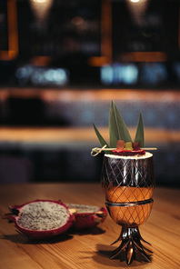 selective focus of delicious tropical alcoholic cocktail decorated with dragon fruit on dark background