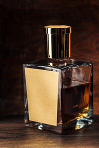 close-up view of luxury cognac bottle with blank label on wooden table