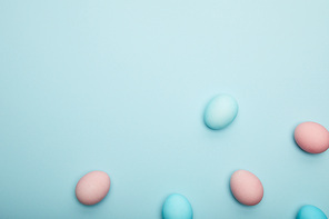 Top view of easter eggs on blue background