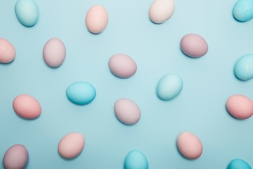 Top view of easter eggs on blue background