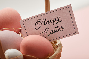Close up of easter chicken and quail egg, card with happy easter lettering