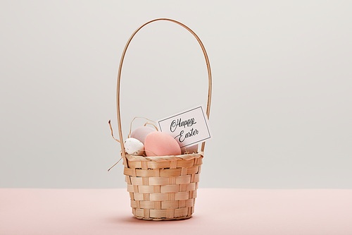 easter chicken and quail egg in straw basket, card with happy easter lettering