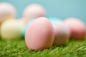 selective focus of easter painted eggs on grass