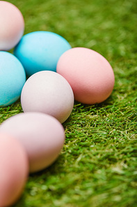selective focus of painted easter eggs on grass