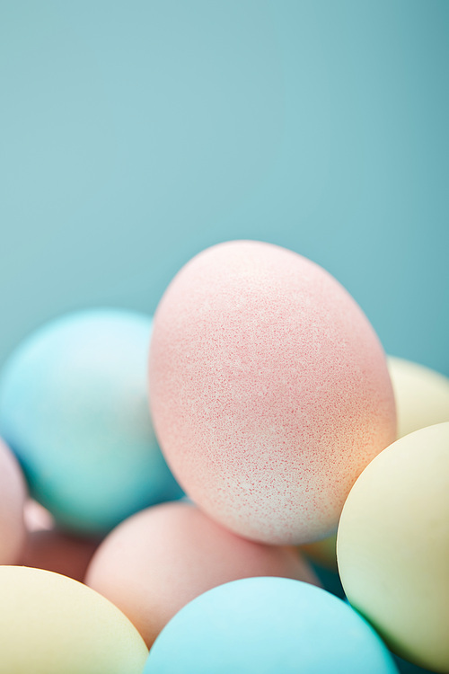 selective focus of painted easter eggs on blue background