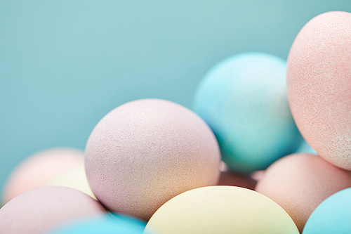 selective focus of painted easter eggs on blue background