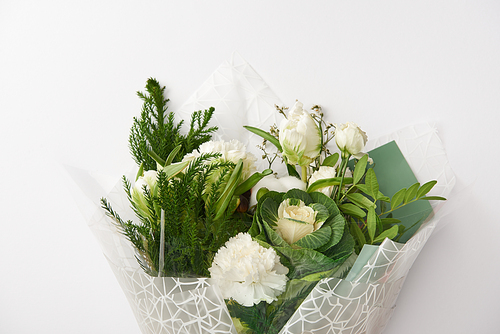 beautiful tender white flowers with green leaves isolated on grey