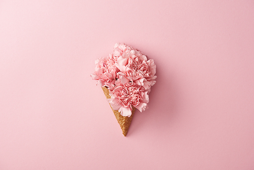beautiful pink carnation flowers in waffle cone isolated on pink