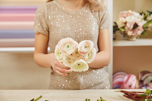 cropped view of florist making bouquet of white peonies