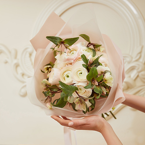 cropped view of florist holding bouquet of white peonies